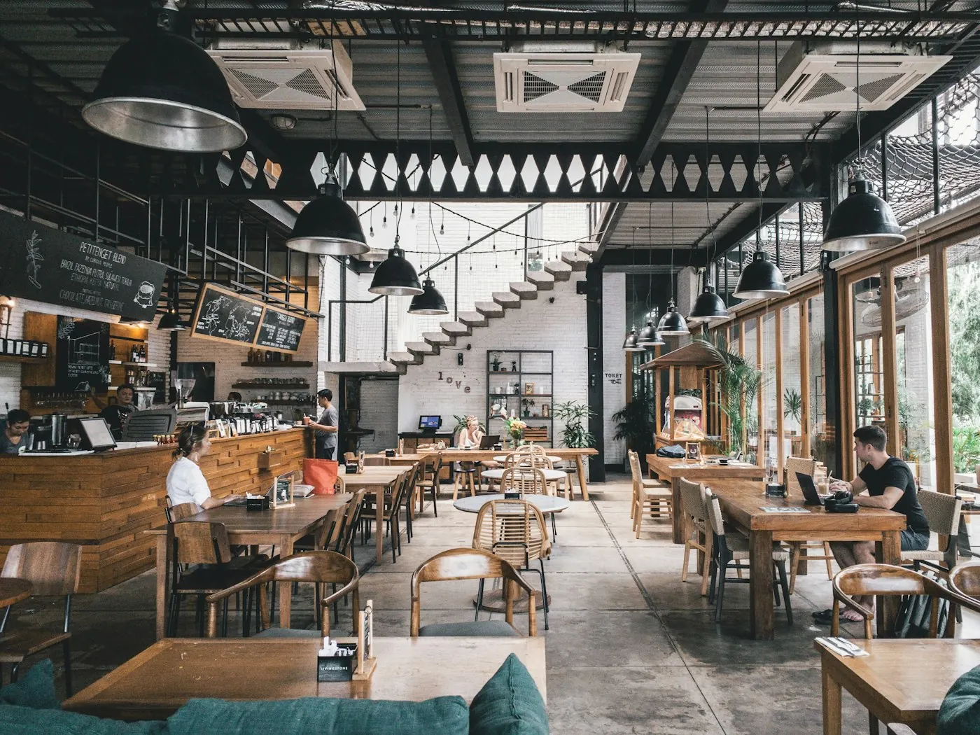 The dining room at Prairie Tap, wood tables and pendant lights